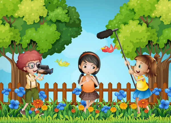 Children filming little girl in the park