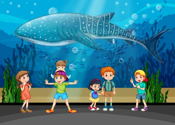 Children and killer whale in aquarium