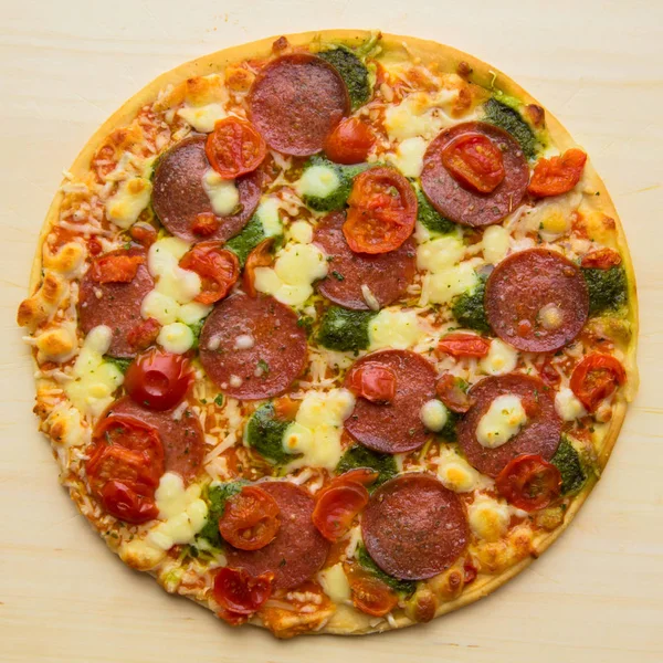 Baked pizza "salami mozzarella pesto". Fast and junk food concep — Stock Photo, Image