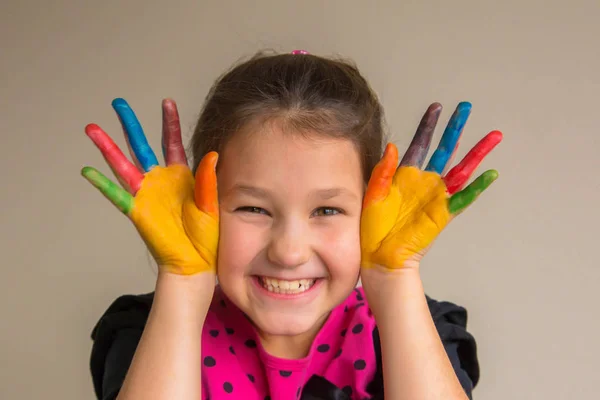 Hild with colorful painted palms and hands with color paints — Stock Photo, Image