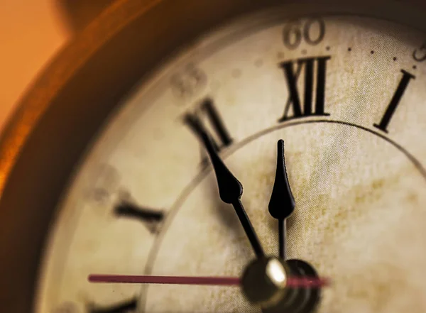 Golden vintage alarm clock showing five to twelve — Stock Photo, Image