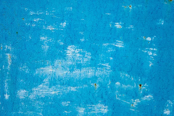 Blue shabby painted surface. Shabby texture with paint smears. Shabby background