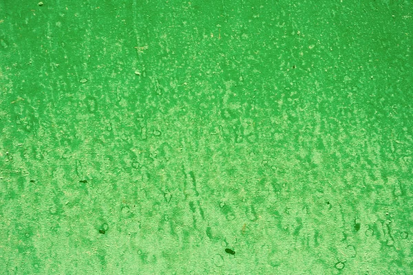Green background with paint spots. Green painted wall texture Acrylic painted surface. Green background with paint spots
