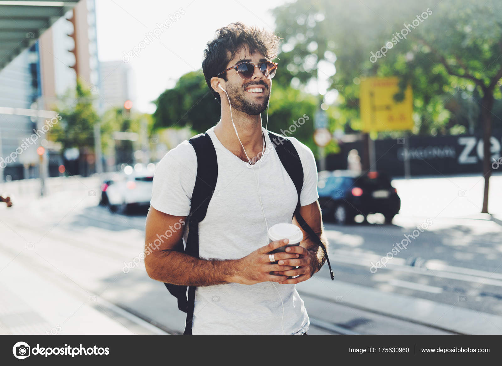 Attractive Young Man Dark Curly Hair Wearing Sunglasses Walking Street  Stock Photo by ©Jkstock 175630960