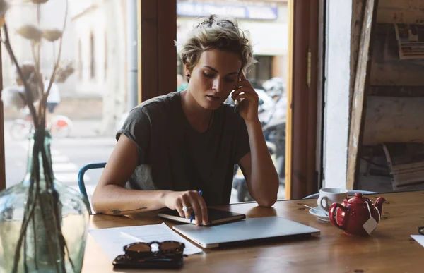 若い起業家の女性は 次の会議を任命するビジネス パートナーを呼び出すことです 美しい白人女性は朝カフェでノート パソコンと携帯電話で座っています — ストック写真
