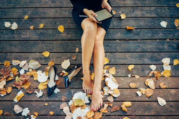 Cropped Image Young Female Sitting Wooden Pier While Reading Electronic — Stock Photo, Image