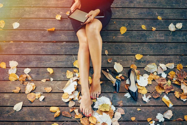 Cropped Image Young Female Sitting Wooden Pier While Reading Electronic Royalty Free Stock Photos