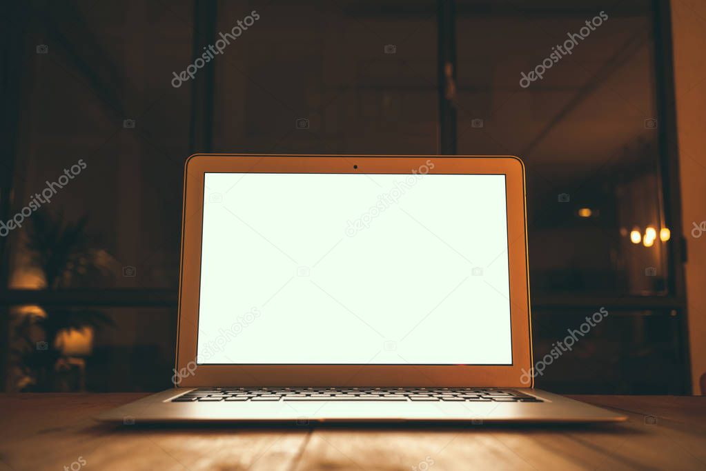 Business workspace with open laptop with white blank screen on vintage wooden desk