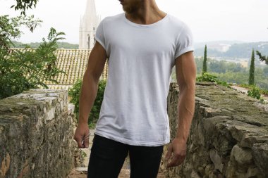 Görüntüsünü şık genç adam açık havada beyaz t-shirt giyen kırpılmış