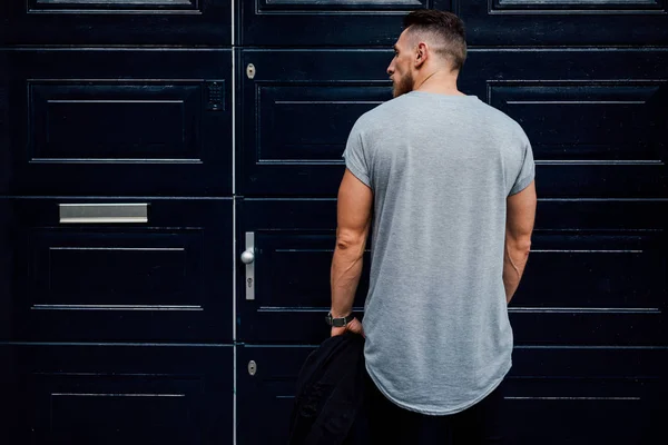 Вид Сзади Мускулистого Молодого Человека Позирующего Двери Улицы — стоковое фото