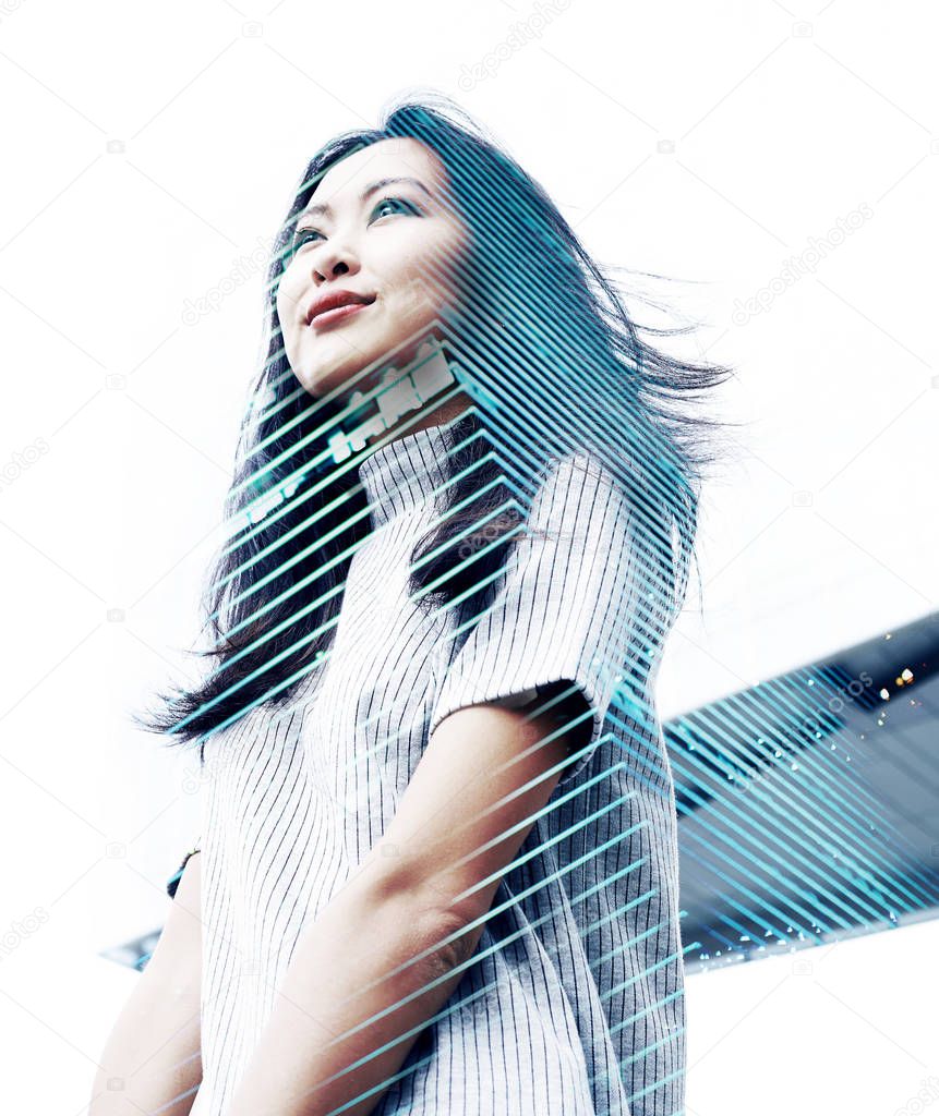 Double exposure portrait with beautiful Asian business woman and modern skyscraper