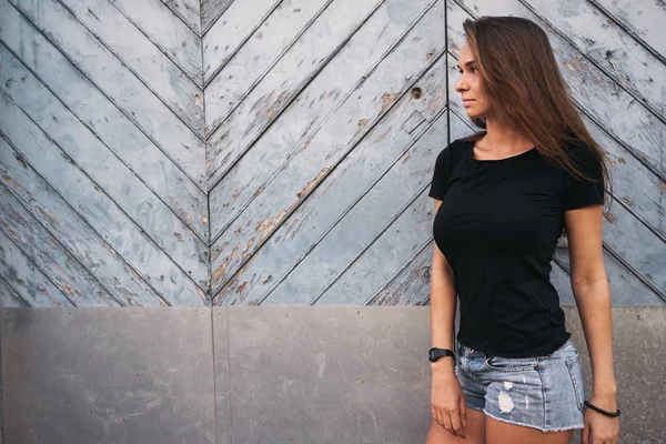 Mooie Jonge Vrouw Een Lege Zwarte Shirt Staande Tegen Licht — Stockfoto