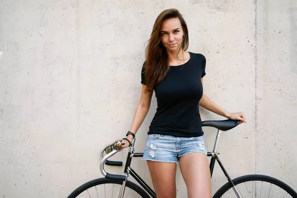 Charming Woman Wearing Blank Black Shirt Posing Bicycle Aginst Concrete — Stock Photo, Image