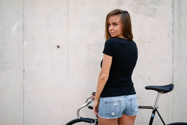 Charming Woman Wearing Blank Black Shirt Posing Bicycle Concrete Wall — Stock Photo, Image