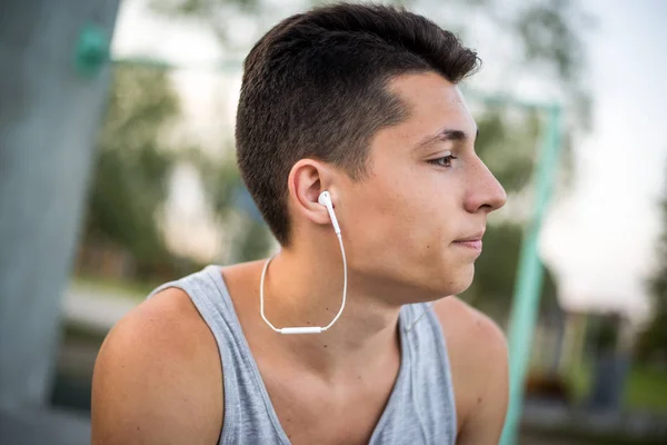 A young guy listens to music before training