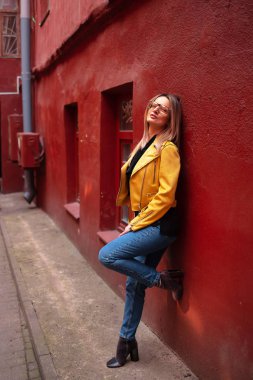 Kız sarı ceketli şehir etrafında yürür