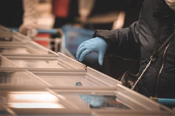 Shopper with gloves in the store — Stock Photo, Image