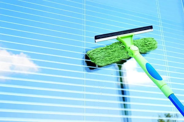 Washing the window with a special brush.