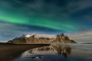 Spectacular aurora borealis near the glacier lagoon Jokulsarlon in Iceland. clipart