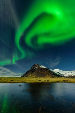 Northern light in Iceland an amazing paradise. Spectacular aurora borealis near the glacier lagoon Jokulsarlon. Beautiful nightscape. clipart