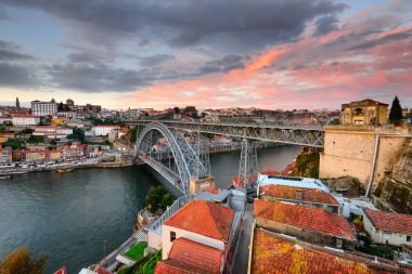 Porto, Portekiz panoramik cityscape Douro nehir ve Dom Luis günbatımında köprü. Oporto şehri geleneksel tekneler ile gün batımında kentsel peyzaj.