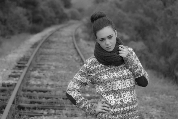 Young woman on train tracks