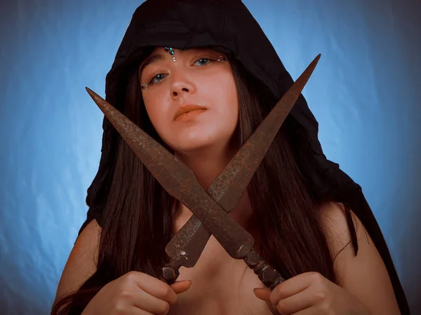Young woman with hood and ancient swords.