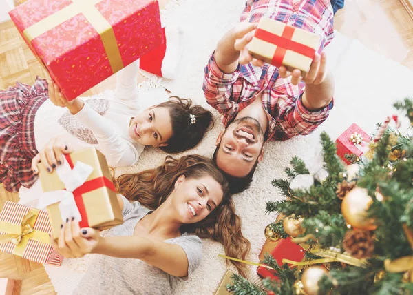 Young family  with  Christmas presents on a Christmas morning