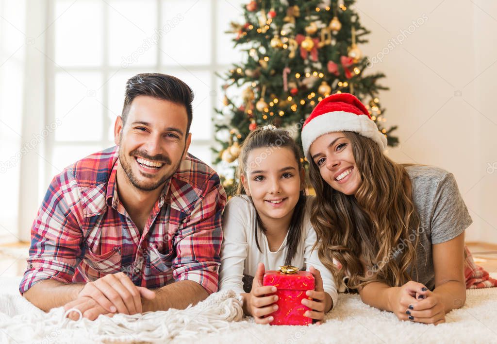 Young family  with  Christmas present on a Christmas morning