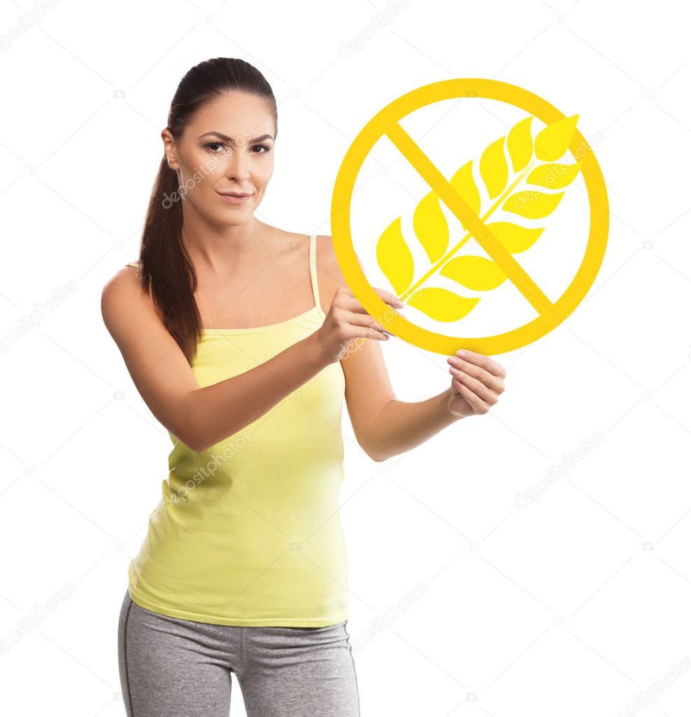 Beautiful, young woman holding a gluten free symbol