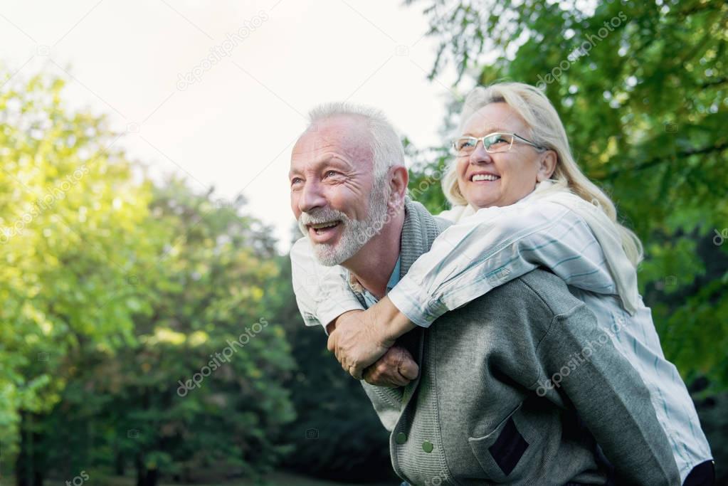 Happy senior couple having fun  outdoors in nature