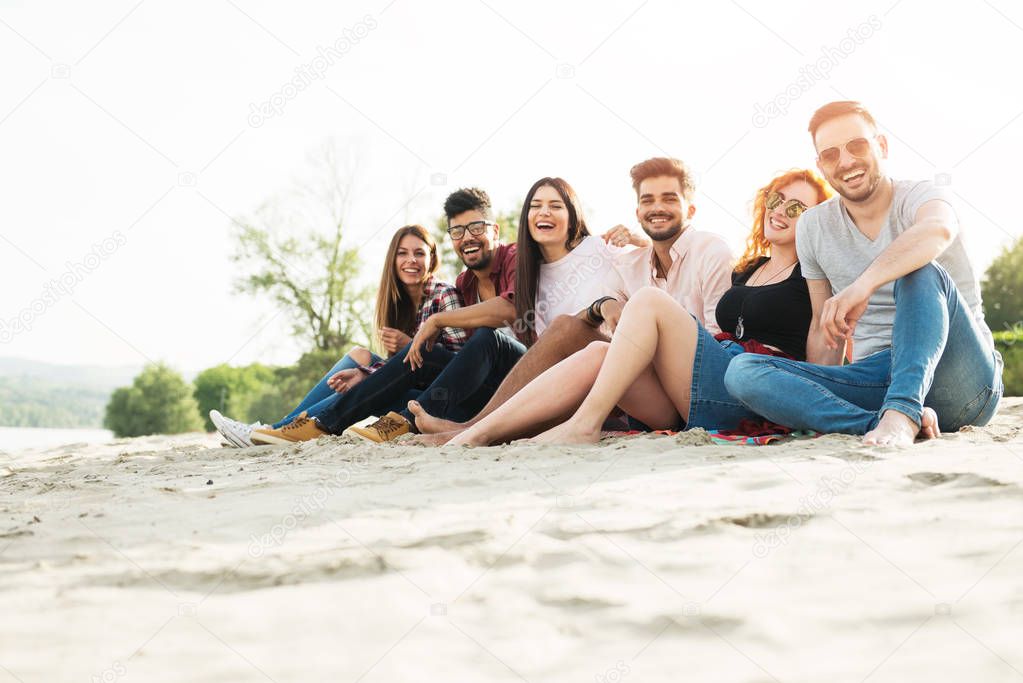 Group of young people having fun outdoors on the beach
