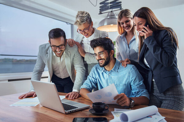 Деловые люди, работающие вместе над проектом на ноутбуке
