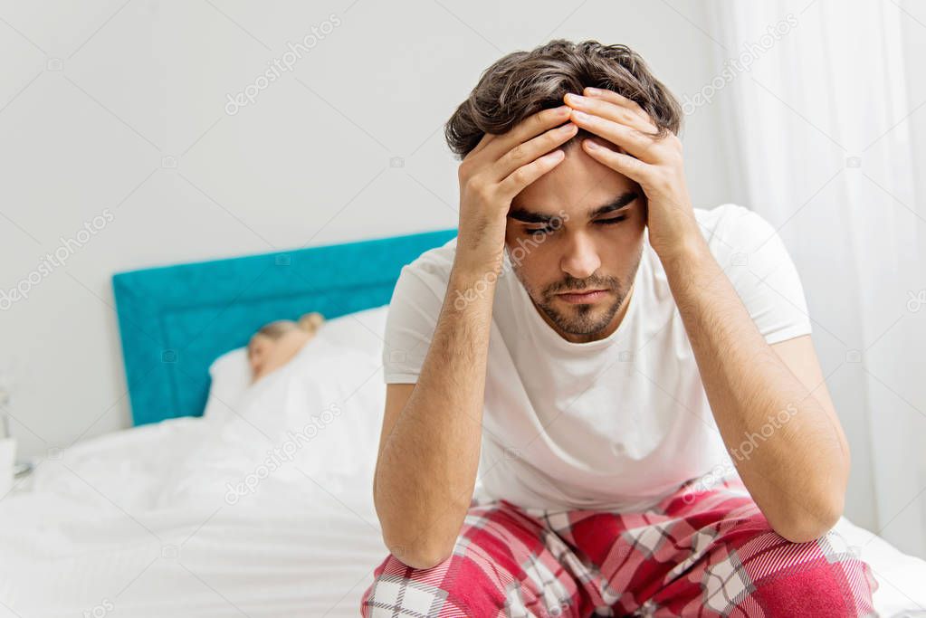 Young couple on the bed; problems in the bedroom  