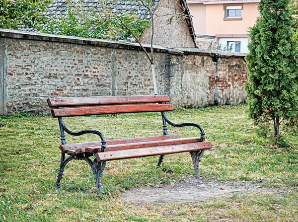 Old wooden bench on green meadow