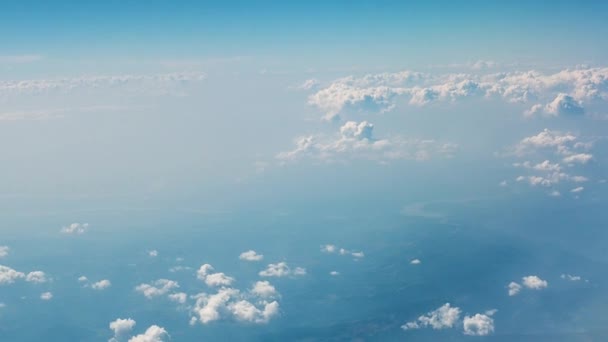 Μπλε με άσπρες σύννεφα του ουρανού. Θέα από τα σύννεφα και τη γη από ένα παράθυρο του αεροπλάνου — Αρχείο Βίντεο