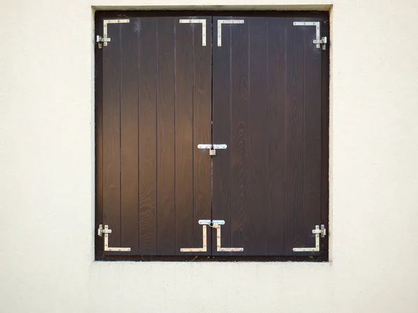 Closed brown wooden window shutters on the white background. — Stock Photo, Image