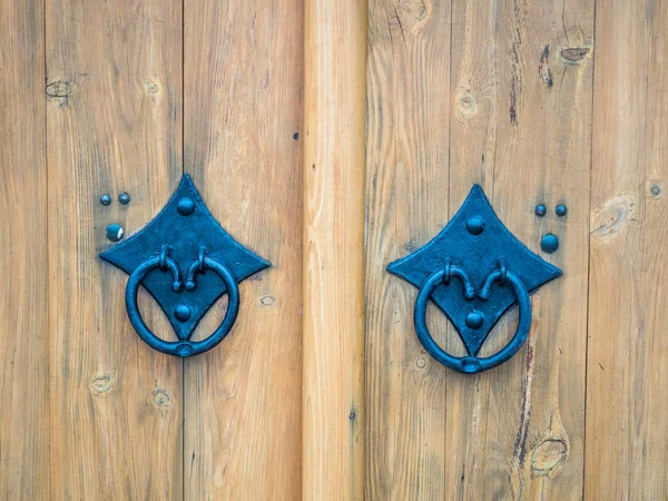 Decorated double door wooden gate with door handle