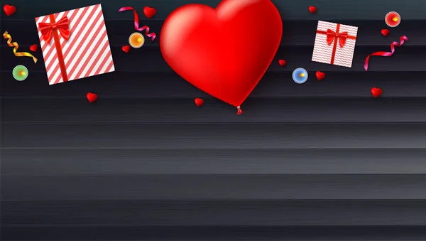Balão inflável vermelho na forma de um coração com caixas de presente, velas, ouropel e confete no fundo de madeira. Modelo para pessoas criativas . —  Vetores de Stock