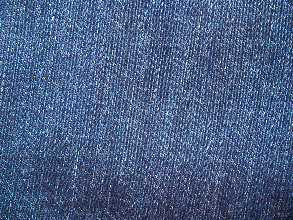 青い綿素材、デニム生地クローズ アップの完全なページ。ジーンズのマクロ写真テクスチャ。背景テクスチャのクローズ アップの最上位のビュー — ストック写真