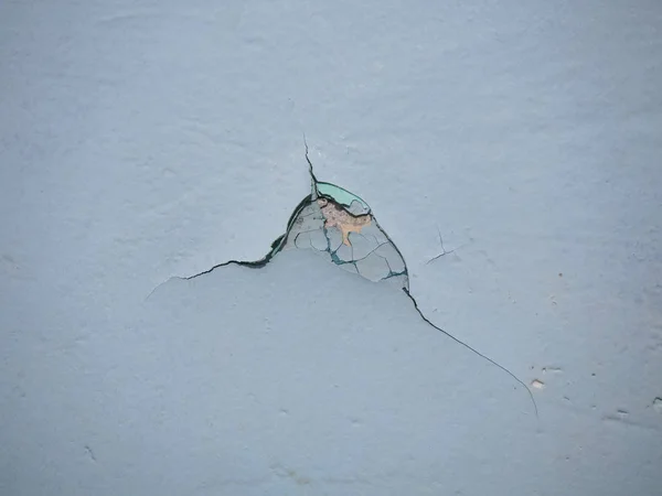 Cracked texture of the paint. Old paint on the wall with old plaster and several layers of paint surface close-up. Macro photography colored texture of background. — Stock Photo, Image