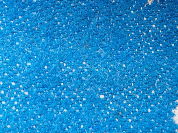 Uma página inteira de material falso sintético azul. Camisola macro, textura de lã de malha. Vista de cima na textura de fundo. Trançado textura de lã close-up . — Fotografia de Stock