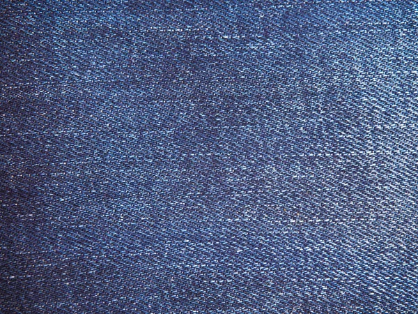 Een volledige pagina met blue katoen materiaal, denim stof close-up. Macro foto textuur van jeans. Zicht van boven op de achtergrond textuur close-up — Stockfoto