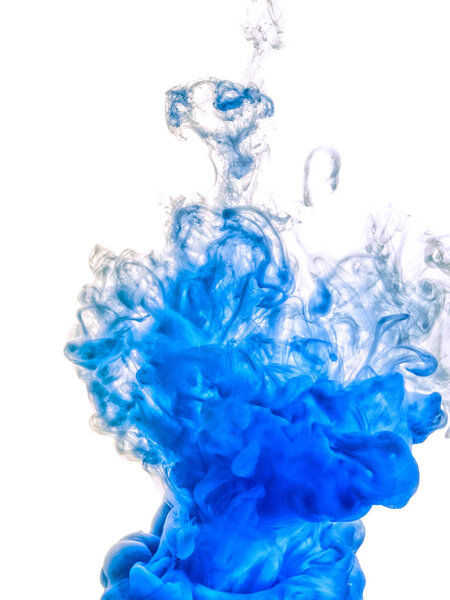 Ink swirl in water isolated on white background. The paint in the water. Soft dissemination a droplets of blue ink in water close-up. Abstract background. Soft focus