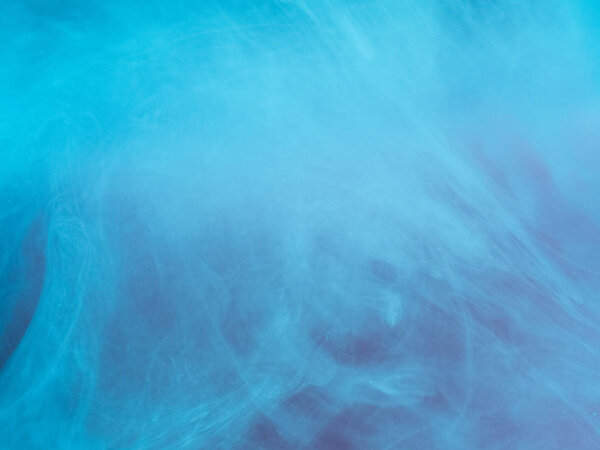 Abstract colored background. Blue smoke, ink in water, the patterns of the universe. Abstract movement, frozen multicolor flow of paint. Horizontal photo with soft focus, blurred backdrop