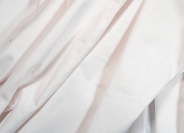 White clean sheet, an abstract background, close up view. Texture of white crumpled textile. Background for wallpapers and banners.