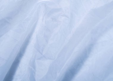 Mavi düz kumaş, yakın görüş. Mavi tekstil, soyut bir arka plan. Mavi yaprak dokusu. Pankartlar ve duvar kağıtları için arkaplan.