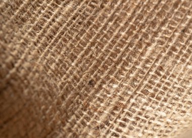 Kahverengi çuval bezi tekstili, yakın görüş. Kahverengi çuval bezi, soyut arka plan. Seçici yumuşak odaklanma. Bulanık arkaplan.