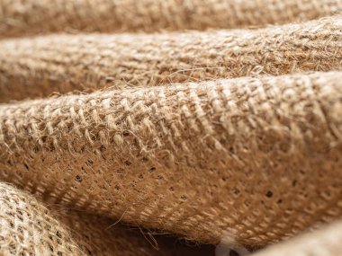 Kahverengi balina dokusu, yakın görüş. Buruşuk çuval bezi, soyut bir arka plan. Seçici yumuşak odaklanma. Bulanık arkaplan.