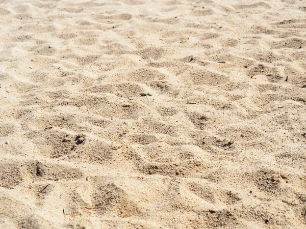 Spiaggia sabbiosa, vista dall'alto. Foto da vicino di sabbia sulla spiaggia tropicale. Contesto per viaggi e vacanze . — Foto Stock